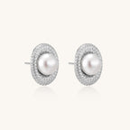 Sterling silver stud earrings with freshwater pearls surrounded by sparkling pavé crystals on white background.