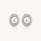 Sterling silver stud earrings with freshwater pearls surrounded by sparkling pavé crystals on white background.