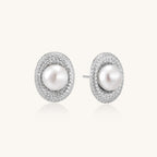 Sterling silver stud earrings with freshwater pearls surrounded by sparkling pavé crystals on white background.