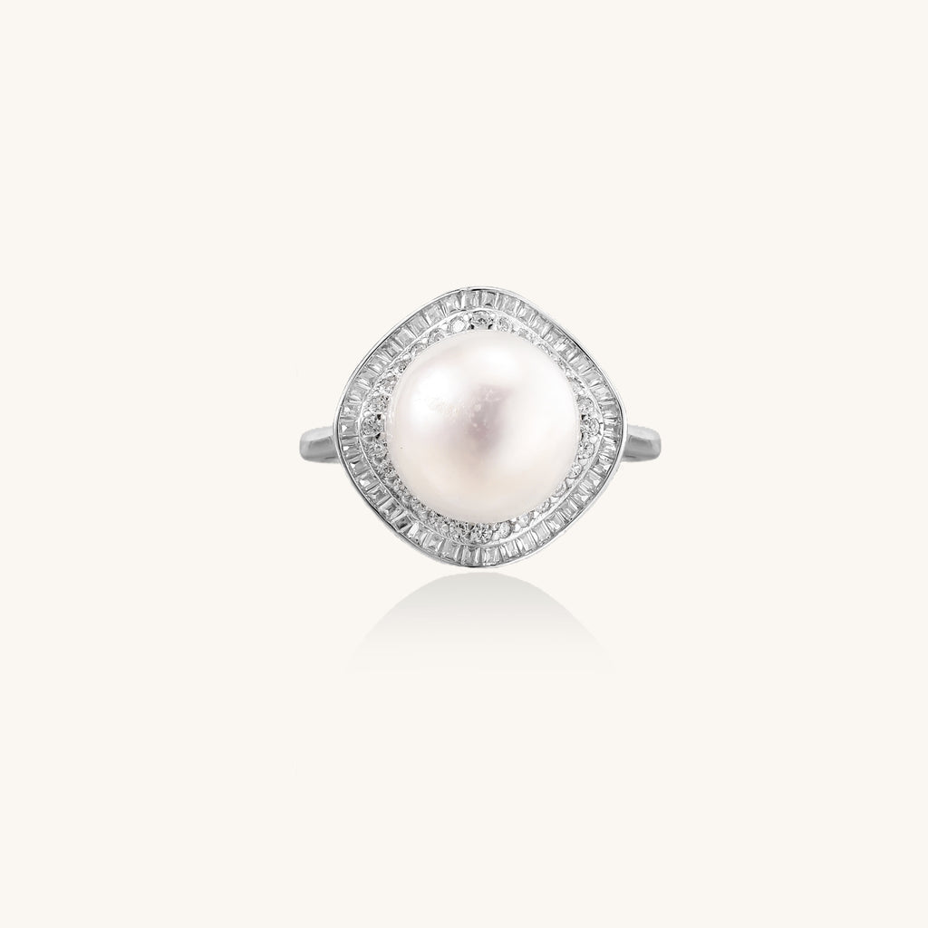 Sterling silver ring with 11mm freshwater pearl surrounded by double diamond halo on white background.