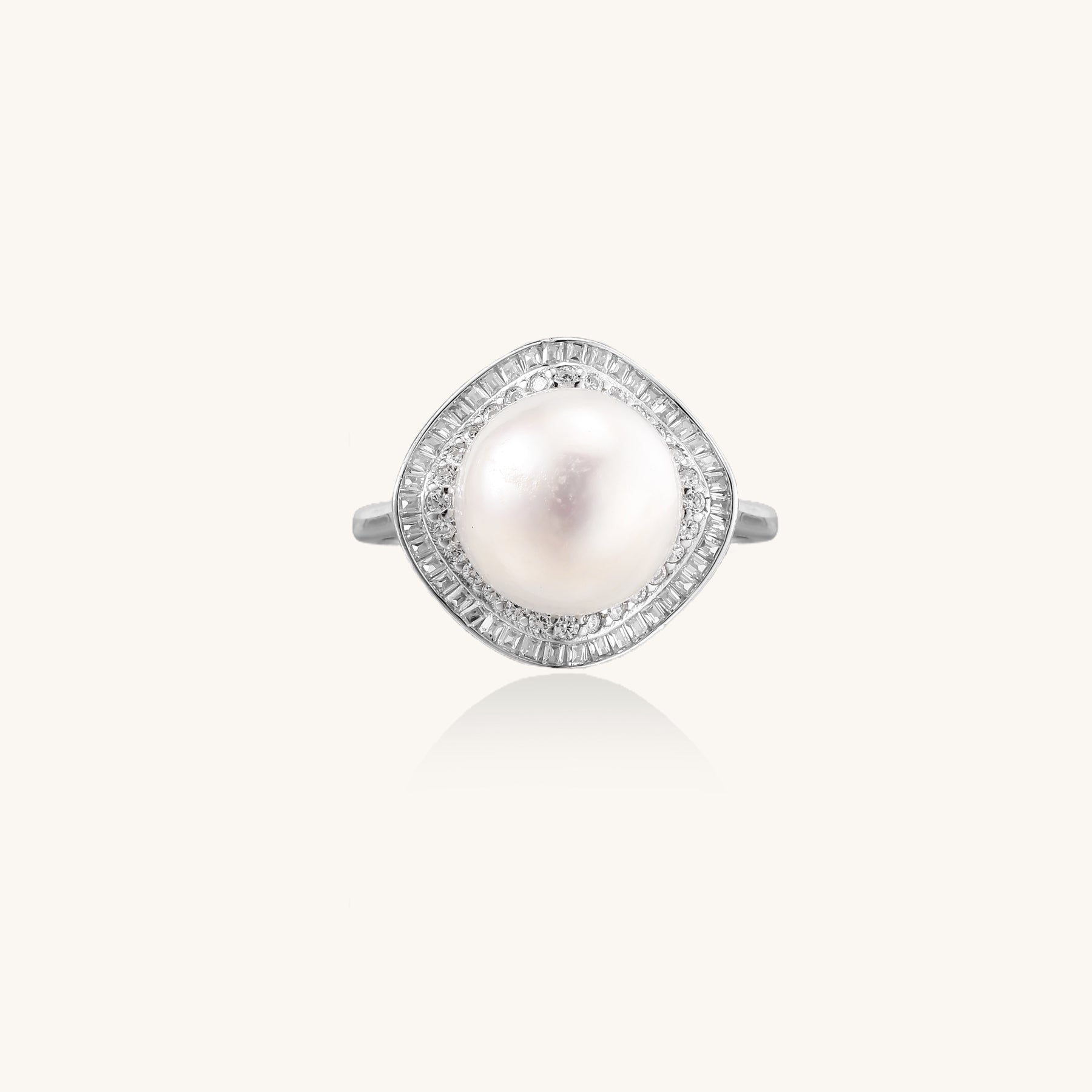 Sterling silver ring with 11mm freshwater pearl surrounded by double diamond halo on white background.