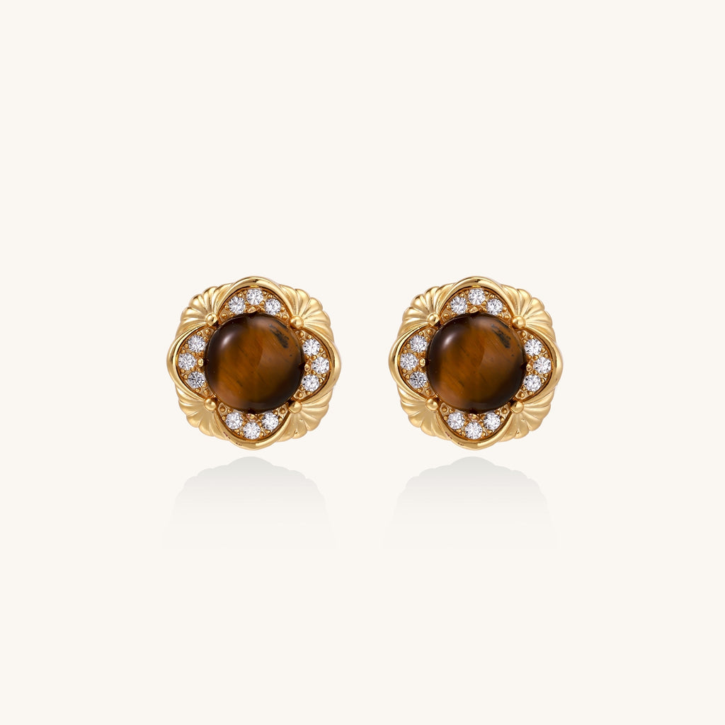 Ornate gold-plated brass stud earrings featuring round tiger's eye stones surrounded by sparkling zirconia in floral design