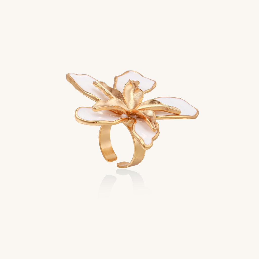 Gold-plated adjustable ring with large white enamel flower design featuring smooth petals outlined in gold